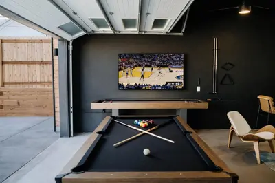 a room with a pool table and a tv at Luxury 5BR - Hot Tub - Game Garage - Mini Golf in Denver