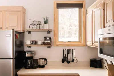 a kitchen with a refrigerator and a window with utensils at Lakefront Keystone Escape - Near Slopes & Trails in Keystone