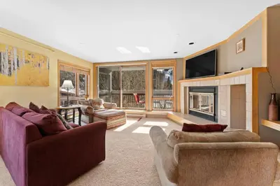 a living room with two couches and a fireplace at Liftside 301 in Keystone