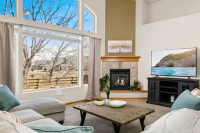 a living room with a couch and a fireplace at Cabin-Style Group Retreat Near RMNP, Lakes and Golf in Loveland