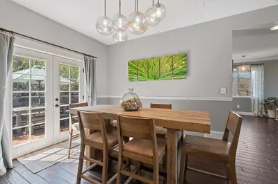 a dining room with a wooden table and chairs at Hillside at Horsetooth Lake & Mountain Views, Near Trails in Fort Collins