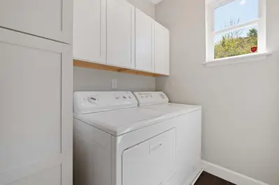 a white laundry room with a washer and a window at Hillside at Horsetooth Lake & Mountain Views, Near Trails in Fort Collins