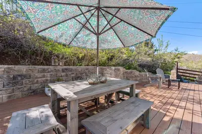 a picnic table with an umbrella and two benches at Hillside at Horsetooth Lake & Mountain Views, Near Trails in Fort Collins