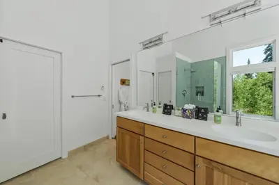 a bathroom with a large sink and a large mirror at Granby Mountain - Forest Views, Hot Tub & Fire Pit in Granby