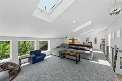 a living room with a couch and a table at Granby Mountain - Forest Views, Hot Tub & Fire Pit in Granby
