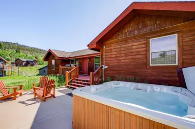 a hot tub on the patio of a house at Beaver Lodge cabin in Granby