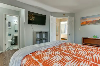 a bedroom with a bed and a tv on the wall at 4 Mi to Dtwn Loveland Home with Hot Tub and Yard in Loveland