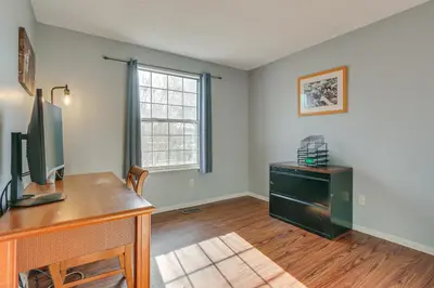an empty room with a desk and a tv at 4 Mi to Dtwn Loveland Home with Hot Tub and Yard in Loveland
