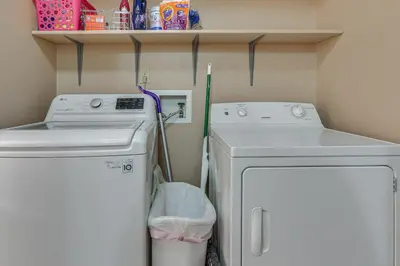 a small laundry room with a washer and dryer at 4 Mi to Dtwn Loveland Home with Hot Tub and Yard in Loveland