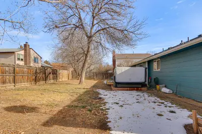 a television sitting on a bench next to a house at 4 Mi to Dtwn Loveland Home with Hot Tub and Yard in Loveland