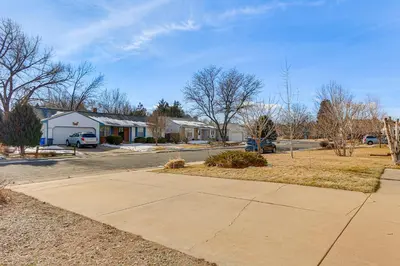 a sidewalk in a residential neighborhood with houses at 4 Mi to Dtwn Loveland Home with Hot Tub and Yard in Loveland