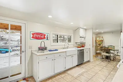 a kitchen with a cocacola sign on the wall at Twin Fawns cabin in Estes Park
