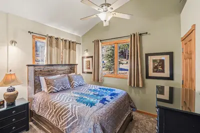 a bedroom with a bed and a ceiling fan at Lakeview Retreat 19A condo in Estes Park