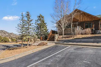 an empty road in front of a log house at Lakeview Retreat 19A condo in Estes Park