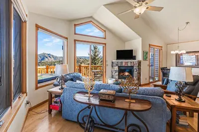 a living room with a blue couch and a fireplace at Lakeview Retreat 19A condo in Estes Park