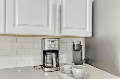 a kitchen counter with two cups and a coffee maker at Black Hawk Getaway with Hot Tub cabin in Black Hawk