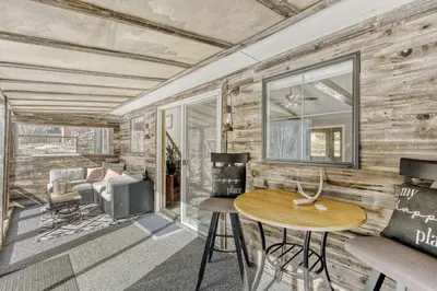a cabin with a table and chairs in a room at Black Hawk Getaway with Hot Tub cabin in Black Hawk