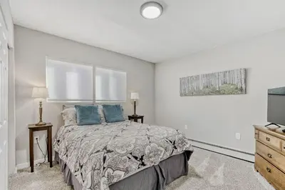 a bedroom with a bed and a dresser at Black Hawk Getaway with Hot Tub cabin in Black Hawk