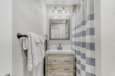 a bathroom with a sink and a mirror at Black Hawk Getaway with Hot Tub cabin in Black Hawk