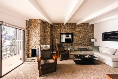 a living room with a couch and a table at Spacious Family Condo - Walk to Dillon Reservoir in Dillon