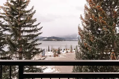 a view from a window of a snow covered field at Spacious Family Condo - Walk to Dillon Reservoir in Dillon