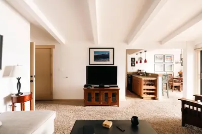 a living room with a flat screen tv on a table at Spacious Family Condo - Walk to Dillon Reservoir in Dillon
