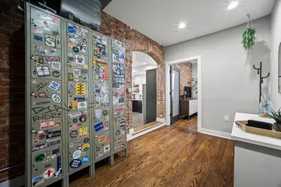 a room with a wall of stickers on the wall at Heart of Downtown City Views Deck BBQ in Denver