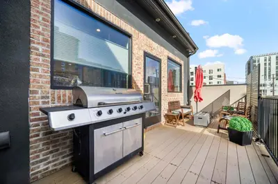 a patio with a grill on a balcony at Heart of Downtown City Views Deck BBQ in Denver