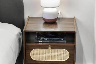a nightstand with a lamp on it next to a bed at Heart of Downtown City Views Deck BBQ in Denver