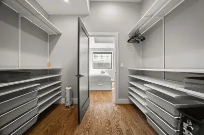 a kitchen with white cabinets and a door to a bathroom at Heart of Downtown City Views Deck BBQ in Denver