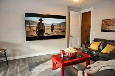 a living room with a flat screen tv on the wall at Home Spa Retreat Downtown WP Walk to Shops Dining in Winter Park