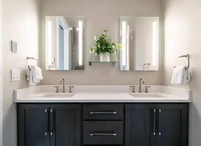 a bathroom with two sinks and two mirrors at Home Spa Retreat Downtown WP Walk to Shops Dining in Winter Park
