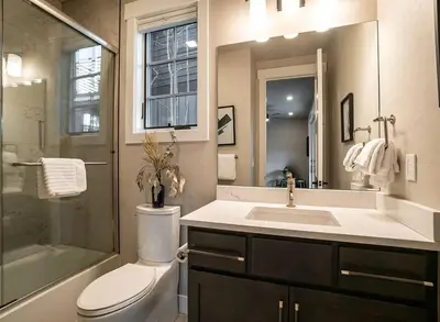 a bathroom with a sink and a toilet and a shower at Home Spa Retreat Downtown WP Walk to Shops Dining in Winter Park