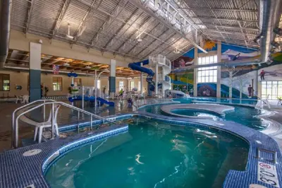 a large indoor swimming pool with a water slide at Home Spa Retreat Downtown WP Walk to Shops Dining in Winter Park