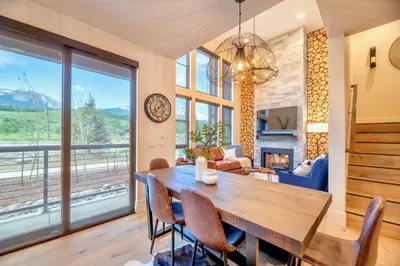 a dining room with a table and chairs and a fireplace at Luxury Mountain Winter Getaway w Beautiful Views in Silverthorne