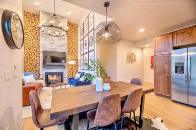 a kitchen and living room with a table and chairs at Luxury Mountain Winter Getaway w Beautiful Views in Silverthorne