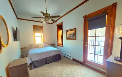 a bedroom with a bed and a ceiling fan at Historic Mining Manor in the Colorado Rockies in Central City