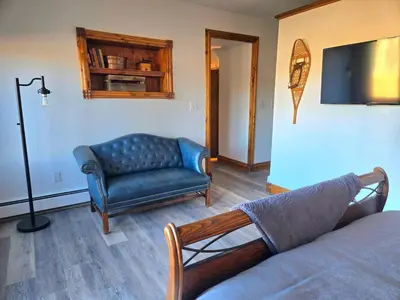 a living room with a couch and a chair at Historic Mining Manor in the Colorado Rockies in Central City