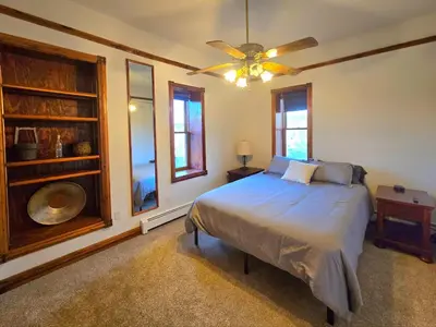 a bedroom with a bed and a ceiling fan at Historic Mining Manor in the Colorado Rockies in Central City