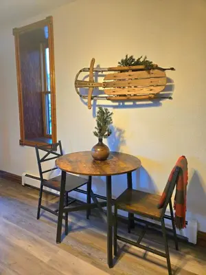a table and a chair and a table with a plant on it at Historic Mining Manor in the Colorado Rockies in Central City