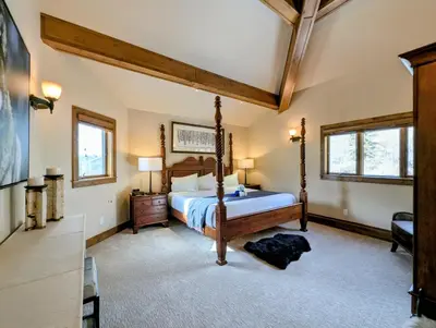 a bedroom with a bed and a dresser and two windows at Enclave 37 by SummitCove Lodging in Snake River Health Services Incorporated Heliport