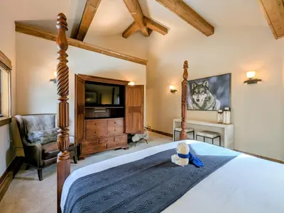 a bedroom with a bed and a tv and a chair at Enclave 37 by SummitCove Lodging in Snake River Health Services Incorporated Heliport