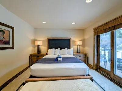 a teddy bear sitting on a bed in a bedroom at Enclave 37 by SummitCove Lodging in Snake River Health Services Incorporated Heliport