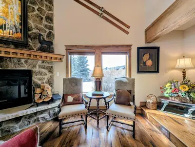 a living room with a table and chairs and a fireplace at Enclave 37 by SummitCove Lodging in Snake River Health Services Incorporated Heliport