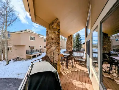 a balcony of a house with a stone fireplace at Enclave 37 by SummitCove Lodging in Snake River Health Services Incorporated Heliport