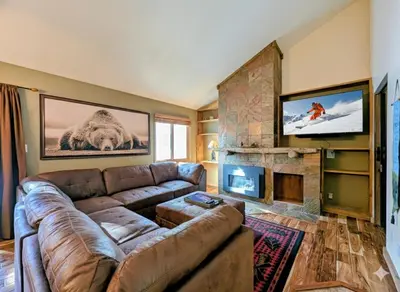 a living room with a couch and a fireplace at Flying Dutchman 1201 by SummitCove Lodging in Keystone