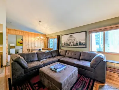 a living room with a leather couch and a table at Flying Dutchman 1201 by SummitCove Lodging in Keystone