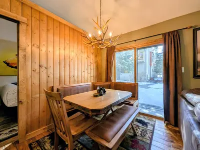 a dining room with a table and a chandelier at Flying Dutchman 1201 by SummitCove Lodging in Keystone