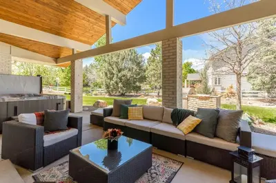 a living room with a couch and a table at Mid-Century Mod - 7 BR Sleeps 22 - Hot Tub & Game Room in Westminster