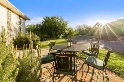 a table and chairs sitting on a patio at Mid-Century Mod - 7 BR Sleeps 22 - Hot Tub & Game Room in Westminster